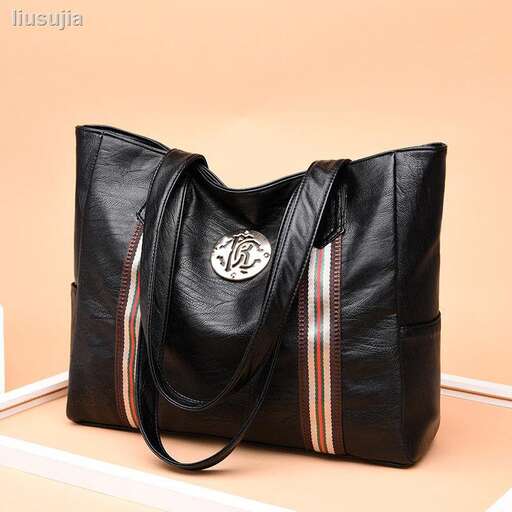 this is a large leather bag with a black leather trim and a zipper.