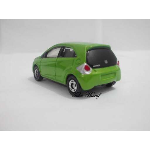 a green car with a red flag on the front.