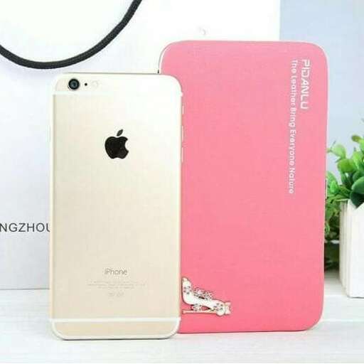 a pink cell phone sitting on top of a table.