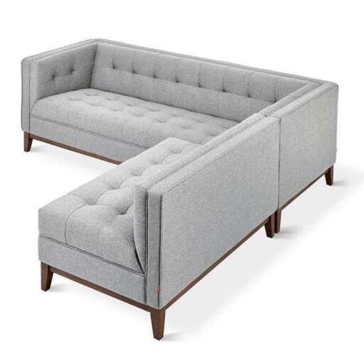 a sofa with a curved arm and legs.