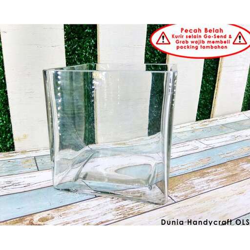 a glass vase sitting on a deck.