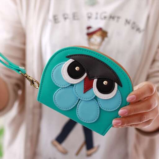 a girl holding a purse with a cute owl on it.