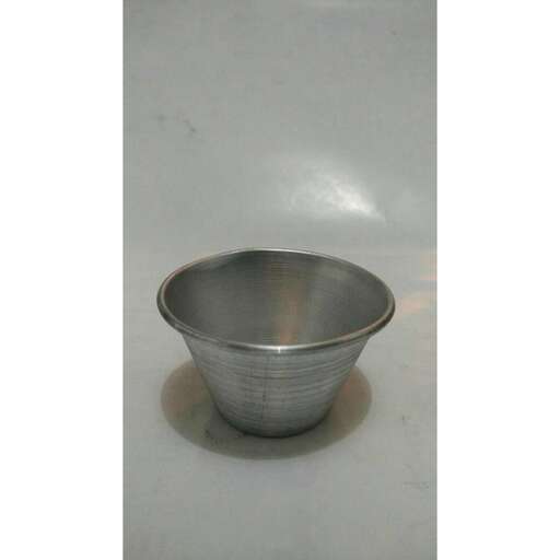 a silver bowl on a white surface.