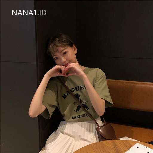 a woman sitting in front of a table with a heart on her hand.
