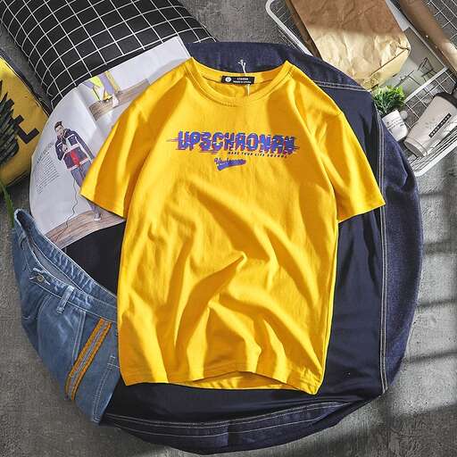 a yellow t - shirt is on the floor.