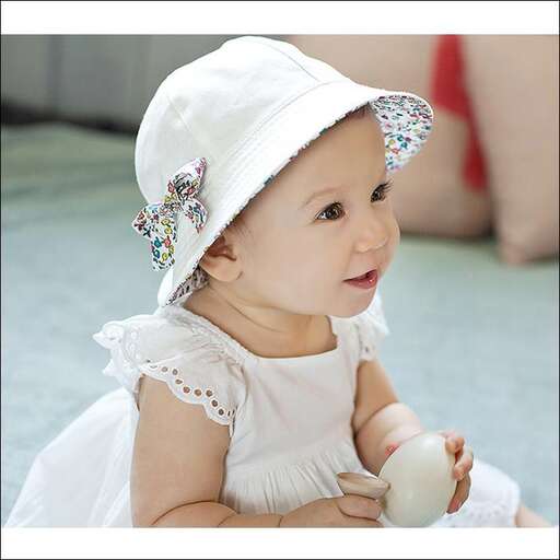 a cute baby girl in a white dress