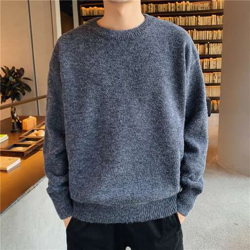 a man in a grey sweater and black pants