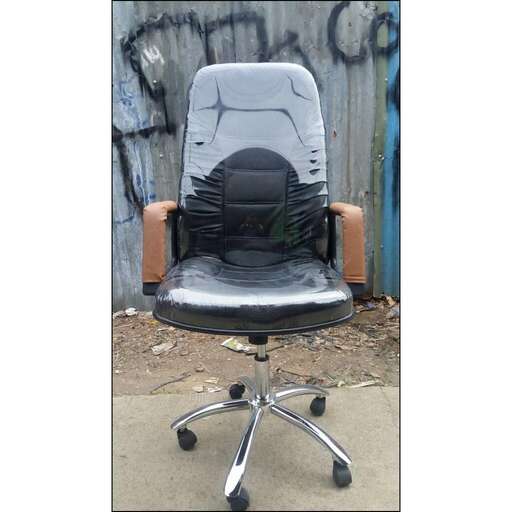 a chair that is sitting in front of a wall.