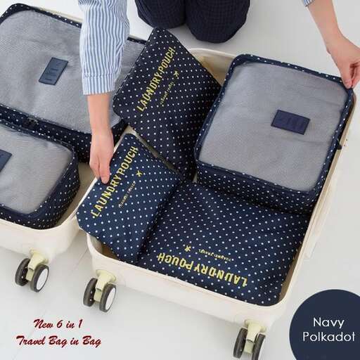 a person is holding a suitcase with wheels.