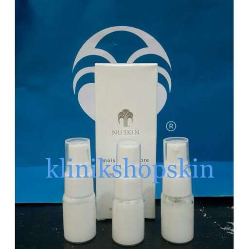 a set of three white candles on a table.