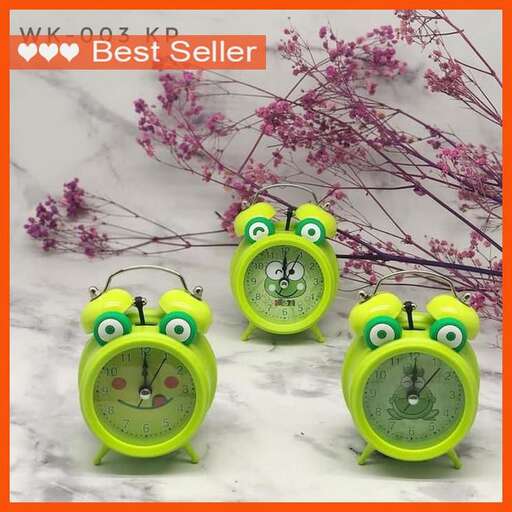 a couple of green alarm clocks with eyes on each side.