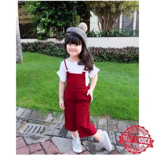 a little girl in red and white