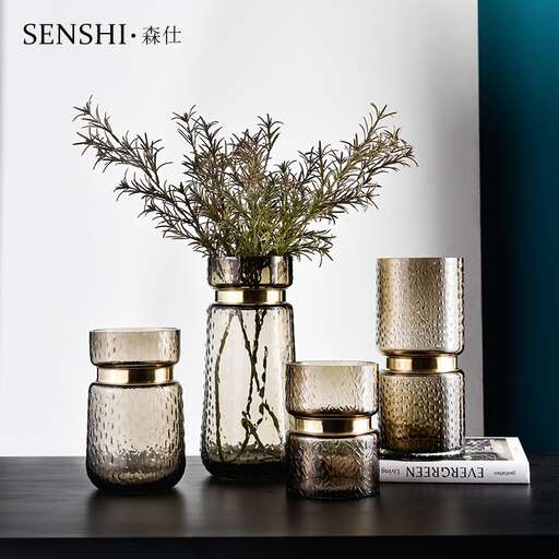 a table with a vase with flowers and candles on it.