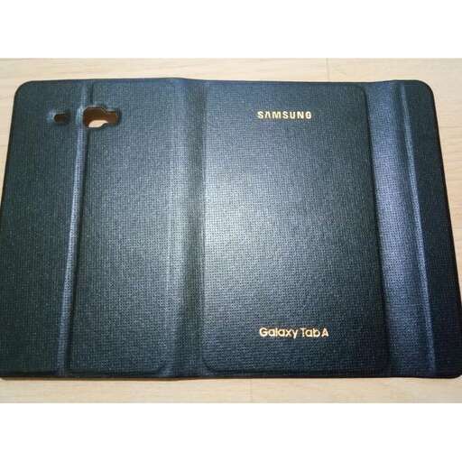 a blue notebook with a cell phone on it.