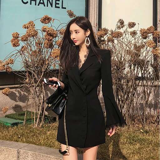 a woman in a black dress and a bag