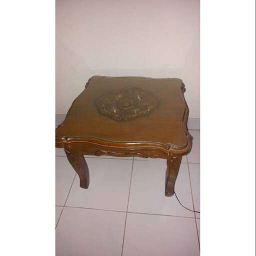 a small wooden table with a bowl on top of it.