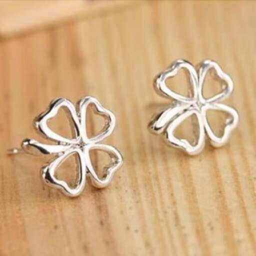 a pair of earrings with a clover