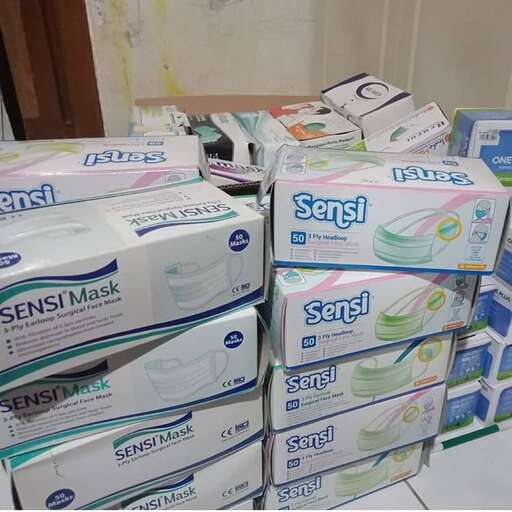 a stack of cardboard boxes sitting on a tiled floor.