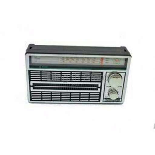 a small radio that is on a white background.