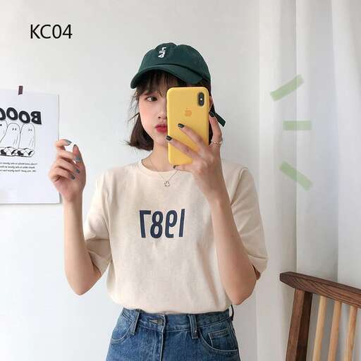 a girl holding a yellow phone in her hands.