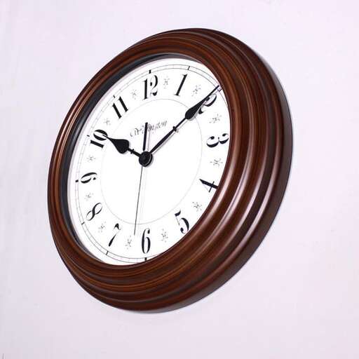 a clock on a wall with a wooden frame.
