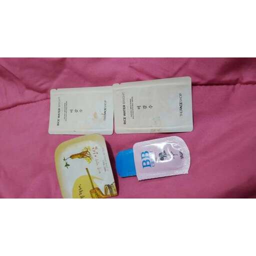 a pink blanket with a small package of pills.