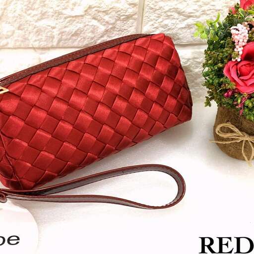 a red purse with a flower pot and a flower pot.