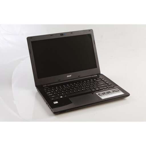 a laptop computer sitting on a white surface.