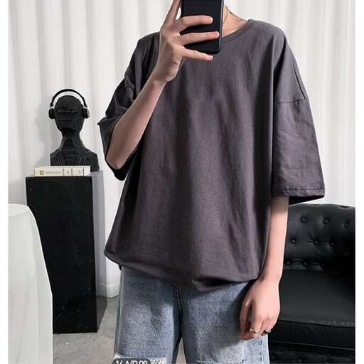 a person standing in a room holding a cell phone.