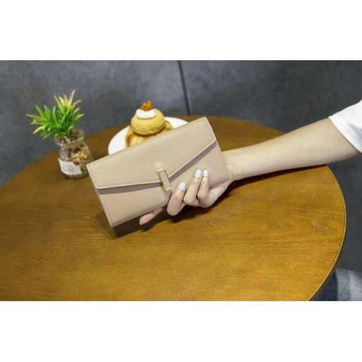 a hand holding a bag with a banana on it.