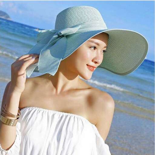 woman in white dress with hat on beach