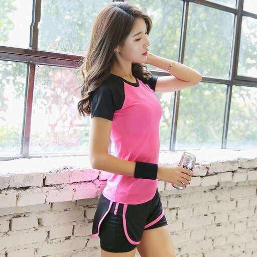 pink and black tee shirt with black shorts and pink shorts in the gym