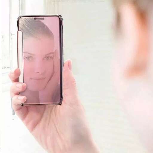 a person holding a cell phone in their hand.