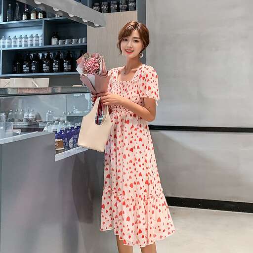 a woman in a dress holding flowers in a shop