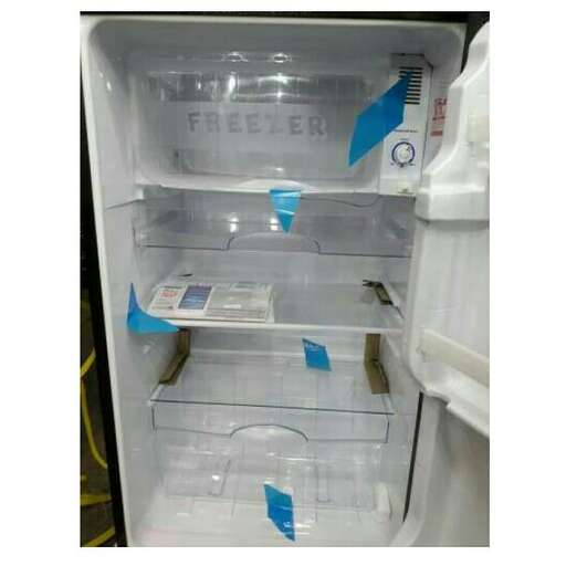 a refrigerator with its doors open and a box of water in it.