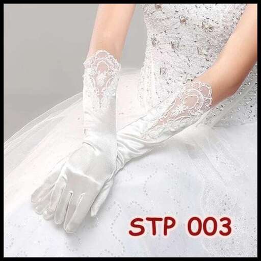 a woman in a white dress and gloves