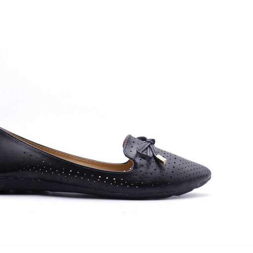 a pair of black flat shoes with a bow on the side.