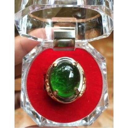 a ring with a green stone in it.