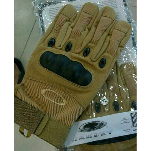 a glove with a face on it and a pair of gloves in the background.