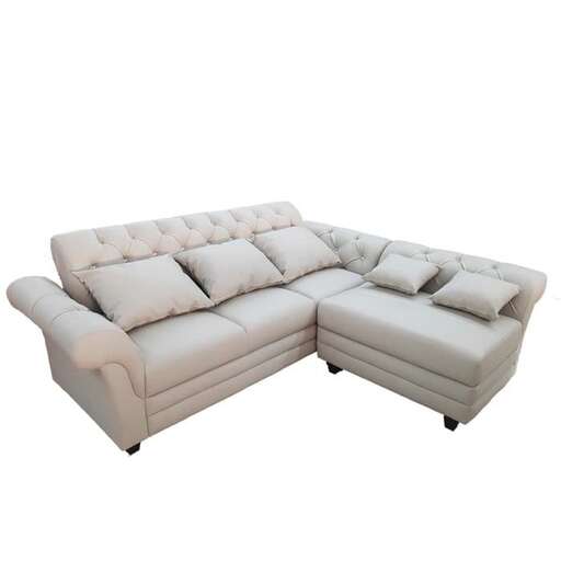 a white leather couch with a white cushion.