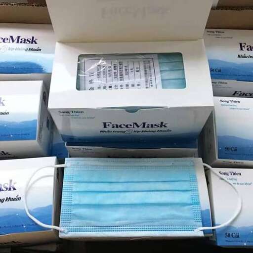 a box of personal items with a blue towel on top.