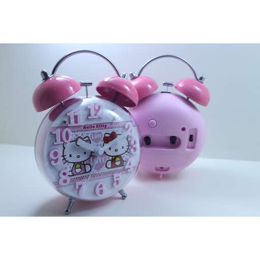 a pink alarm clock with a cute little piggy bank clock.