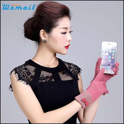 a woman in a black dress holding a cell phone.