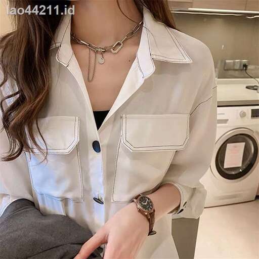 a woman in a white shirt and a watch