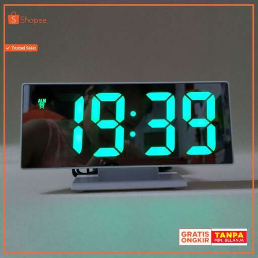 a digital clock with green numbers and numbers.