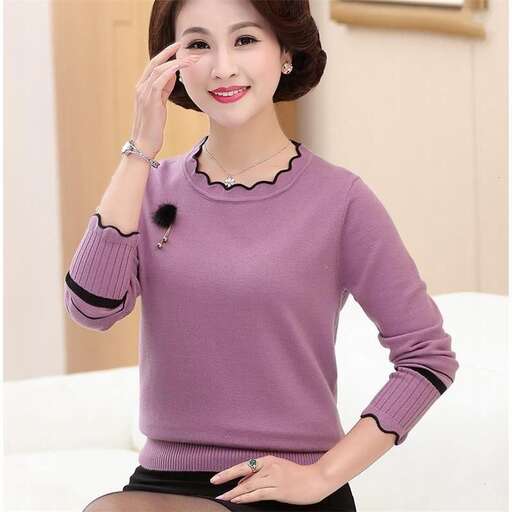 a woman in a purple sweater is talking on a cell phone.