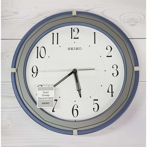 a clock with a blue frame and a white face.