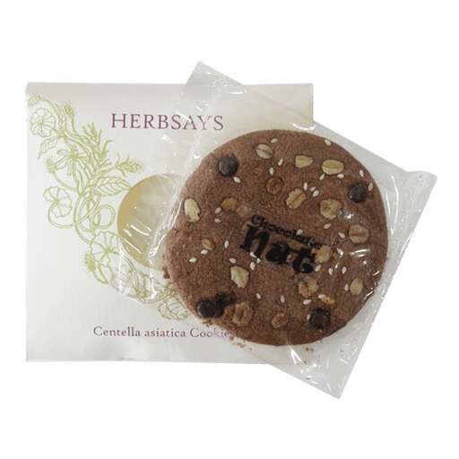 a chocolate cookie with chocolate chips and nuts in a clear bag.