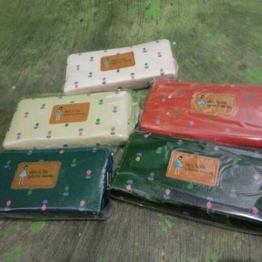 the box is made from recycled plastic and covered in green and red fabric.