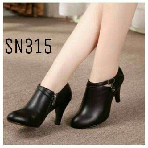 a woman in black high heeled shoes with a heel